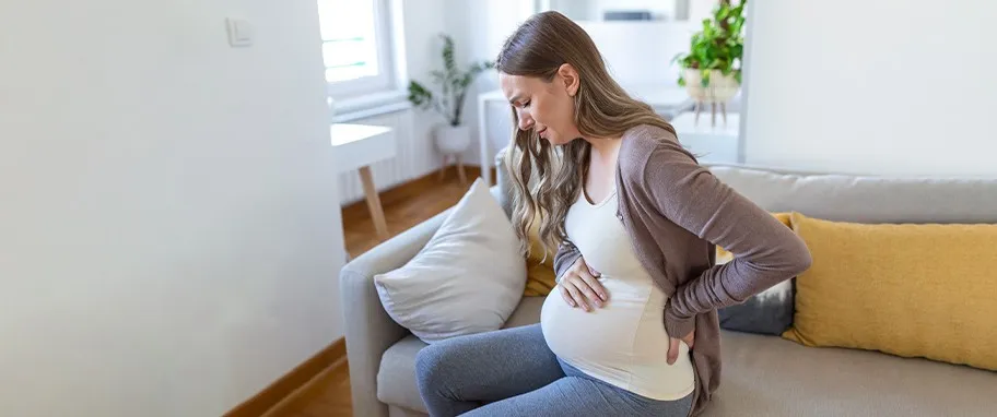 kobieta w ciąży dotykająca brzucha, zwiastuny porodu
