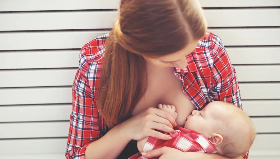 kobieta karmiąca piersią zamyślona