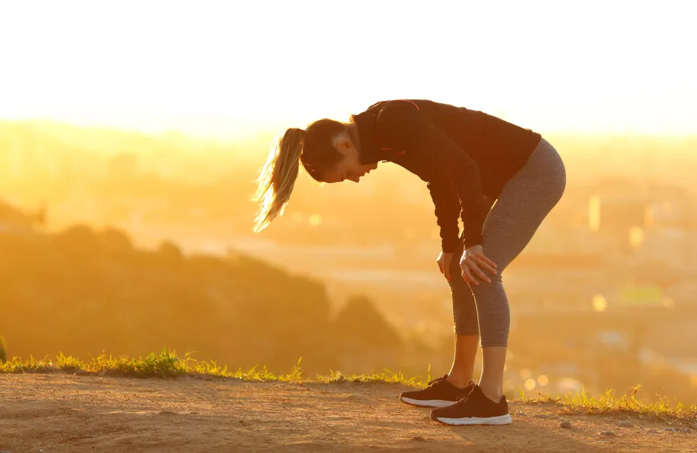 osoba relaksująca się po biegu, zachód słońca