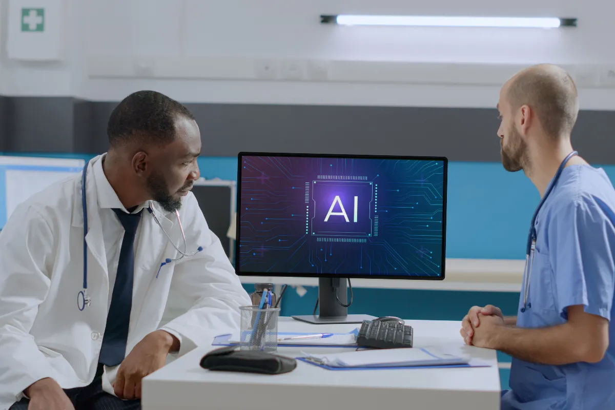 Lekarze dyskutują, jak sztuczna inteligencja zmieni nasze życie, analizując dane na ekranie komputera z symbolem AI.