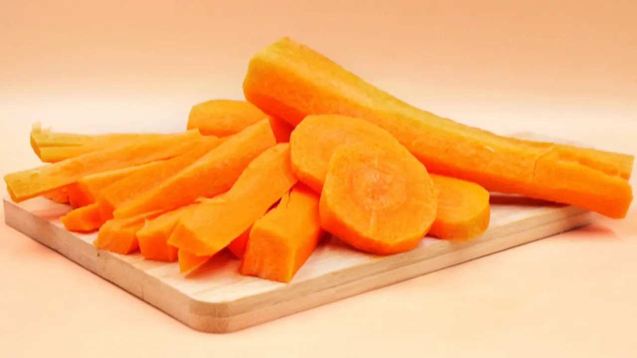 Pokrojone marchewki na desce. Czy gotowana marchewka jest zdrowa? Tak, jest bogata w beta-karoten.