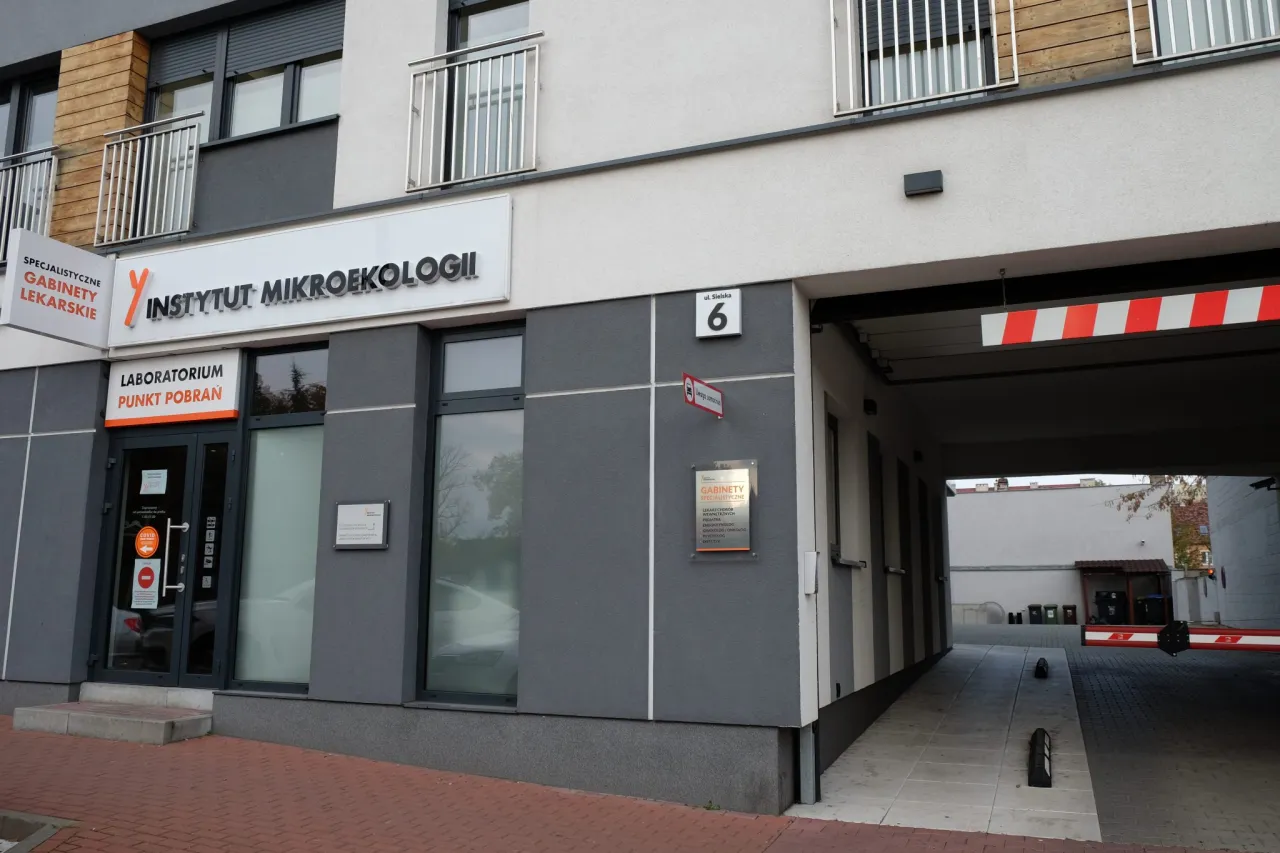 osoba sprawdzająca godziny otwarcia laboratorium na telefonie