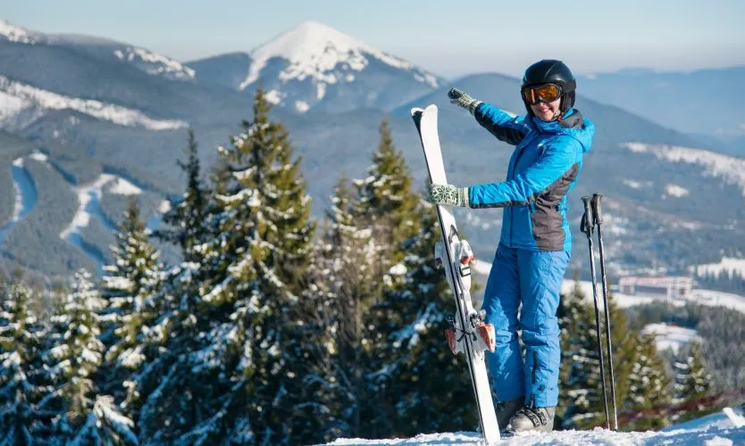 osoba w kompletnym stroju narciarskim na stoku
