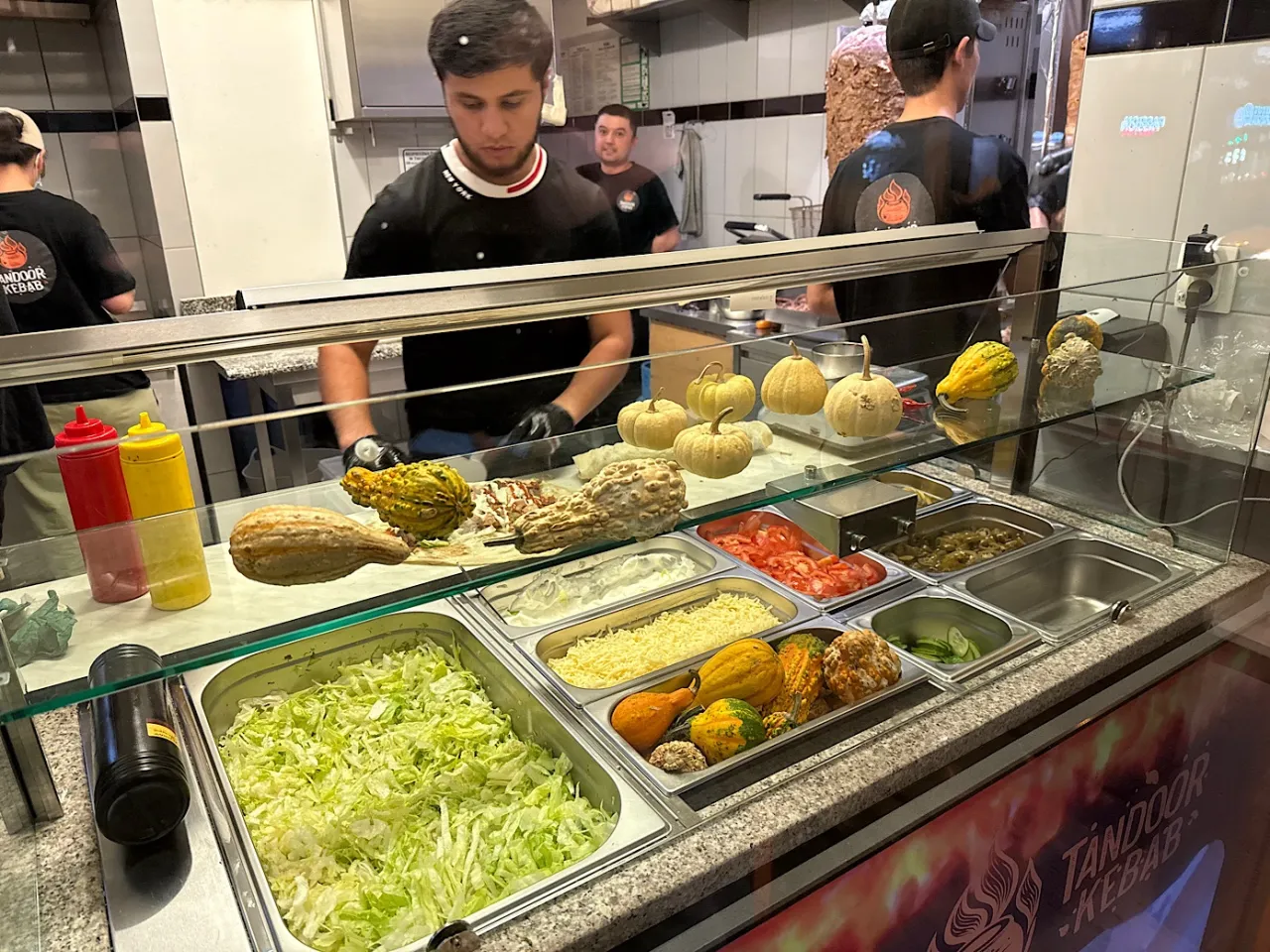 W Tandoor Kebab pracownicy przygotowują dania, a na ladzie leżą dynie. Pytanie gdzie jest najbliższy kebab jest tu retoryczne.