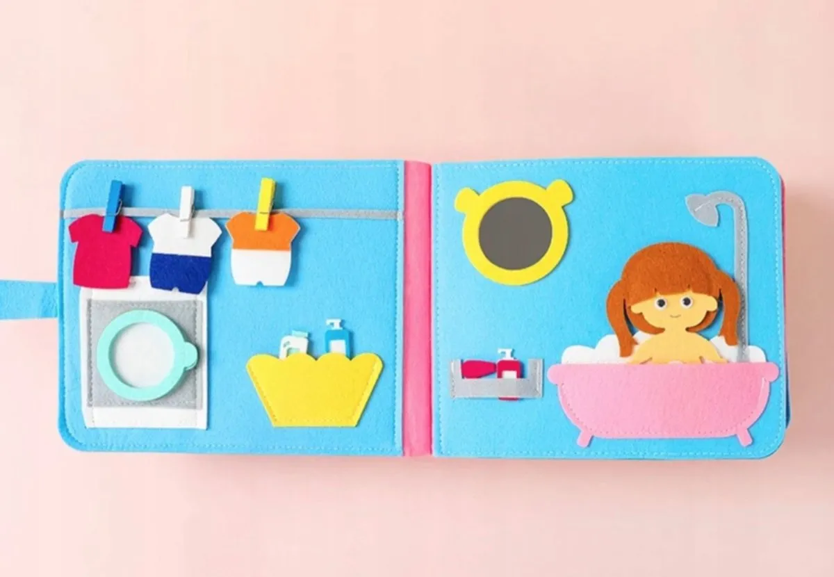 dziecko bawi się filcową książeczką sensoryczną