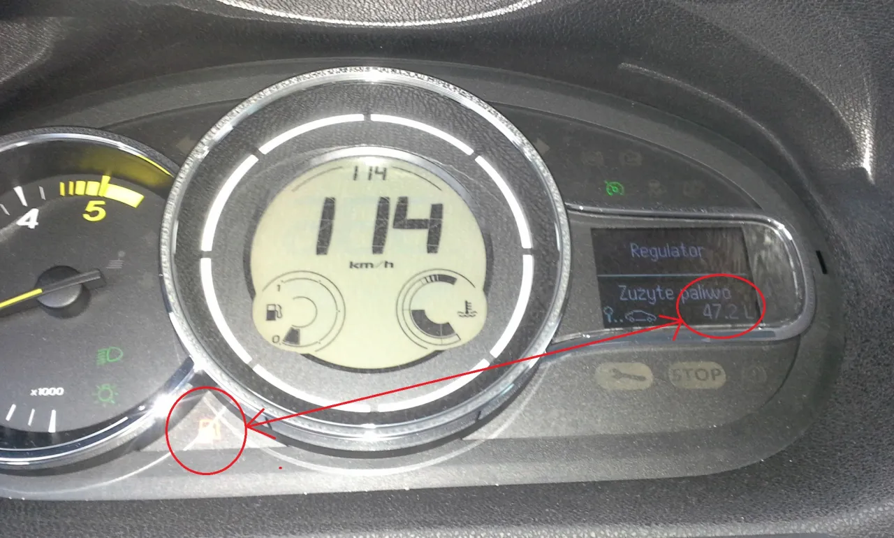 Na desce rozdzielczej Renault Megane 2 widać zużycie paliwa 47.2 L. Kontrolka rezerwy paliwa jest zapalona.