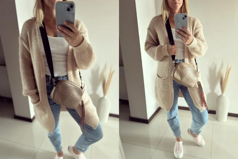 kobieta w modnej stylizacji z długim beżowym kardiganem i jeansami jesienią