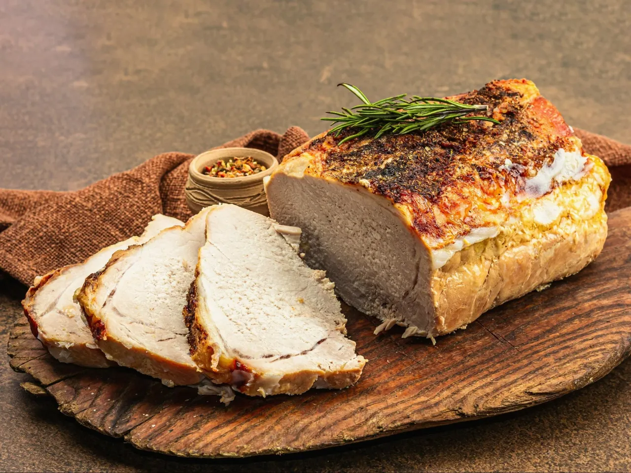 Soczyste, pieczone schab, pokrojone w plastry, z ziołami i przyprawami. Idealne na obiad.