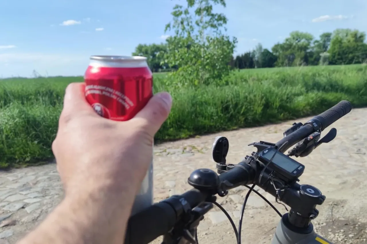Rowerzysta trzyma puszkę napoju, zastanawiając się, czy można stracić prawo jazdy jadąc rowerem.