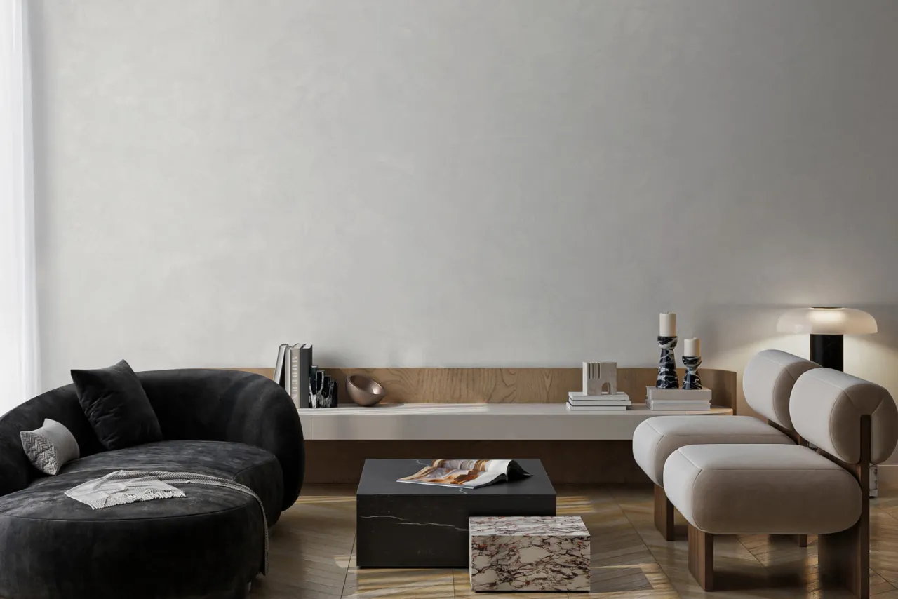 Eleganckie wnętrze z czarną sofą i jasnymi fotelami, emanujące spokojnym luksusem.