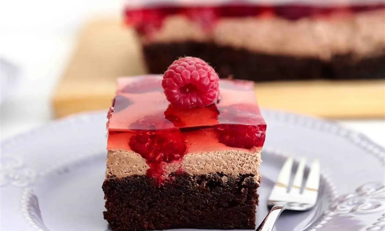 pięknie udekorowane ciasto czekoladowe owocami i słodyczami