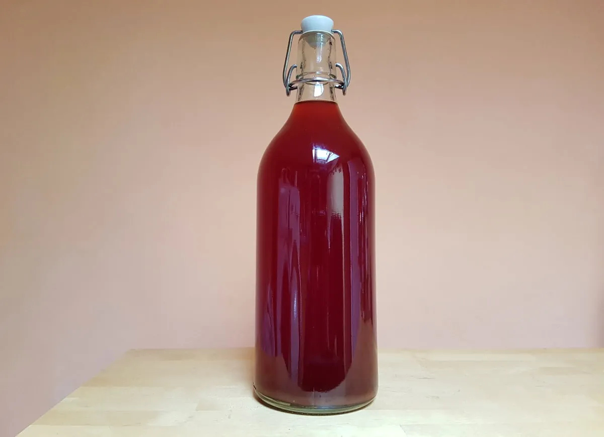 Butelki z nalewką truskawkową w piwnicy