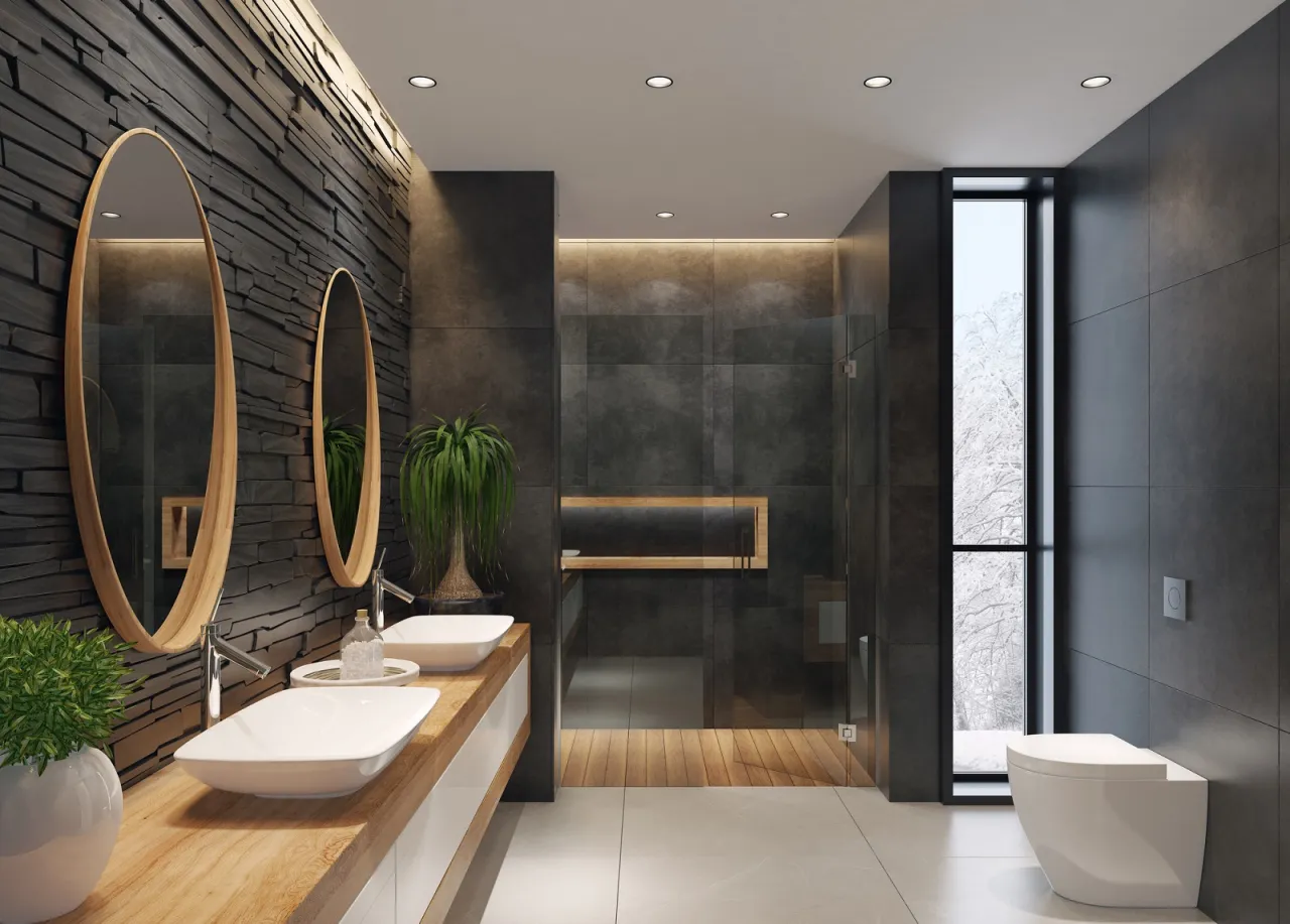 Nowoczesna łazienka z kamienną ścianą, drewnianym blatem i dwoma umywalkami. Dyskretne oświetlenie sufitowe podkreśla elegancję wnętrza. Idealne, jakie oświetlenie do łazienki.