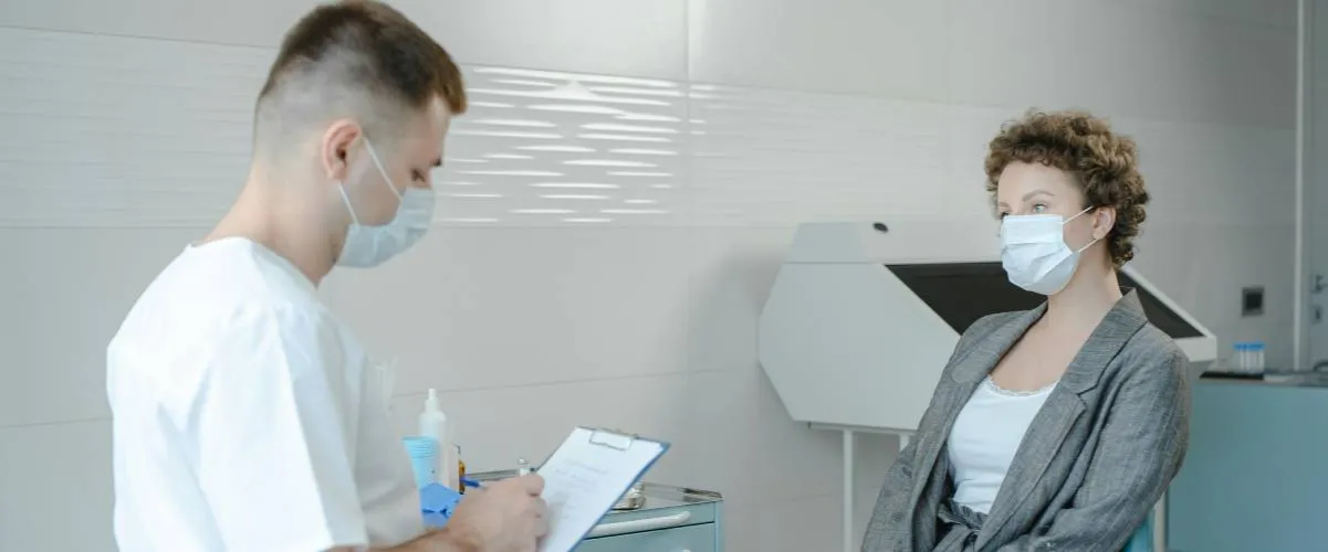 dentysta przeprowadza wywiad z pacjentem