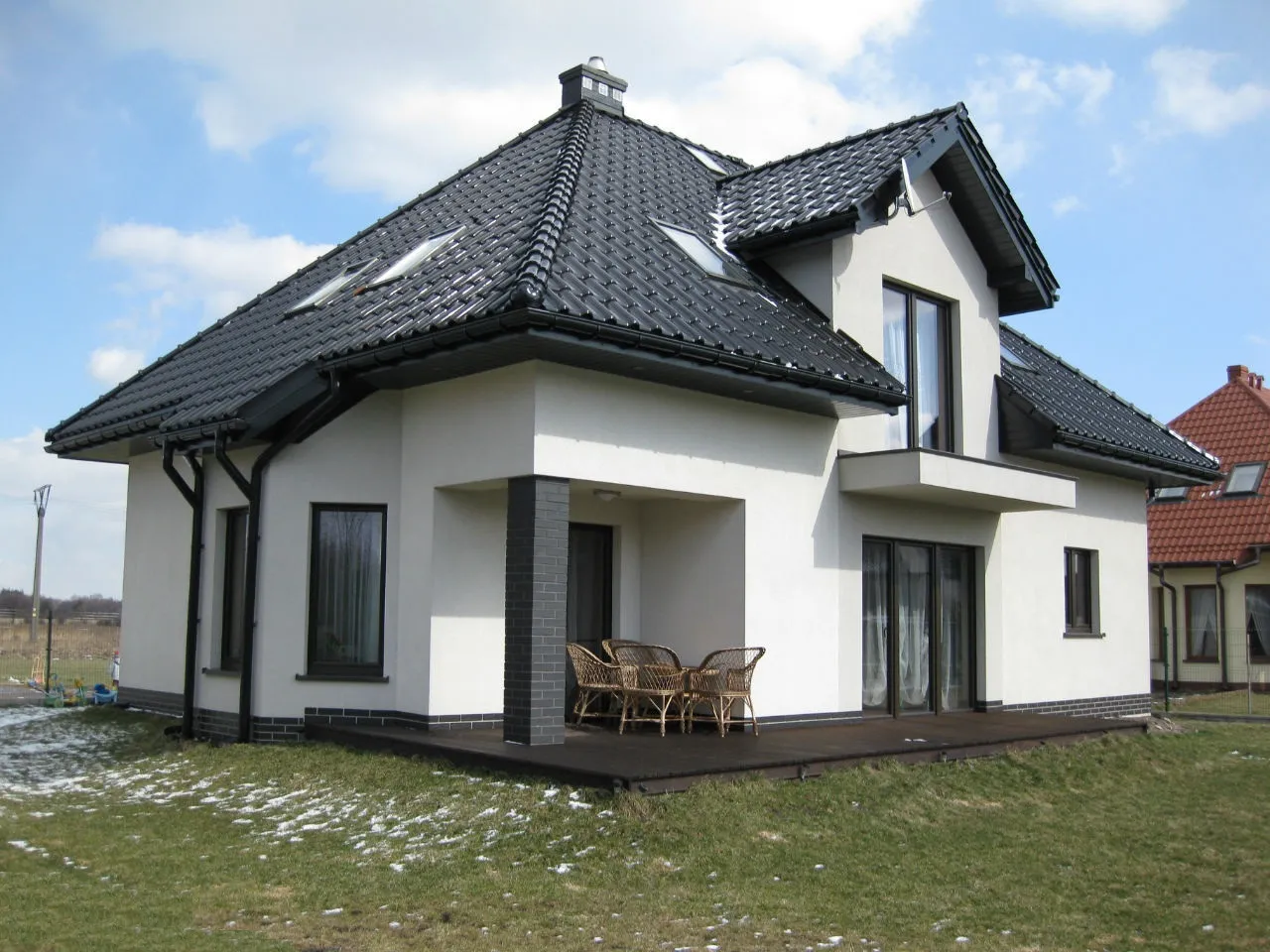 dom z szarym dachem i jasną elewacją