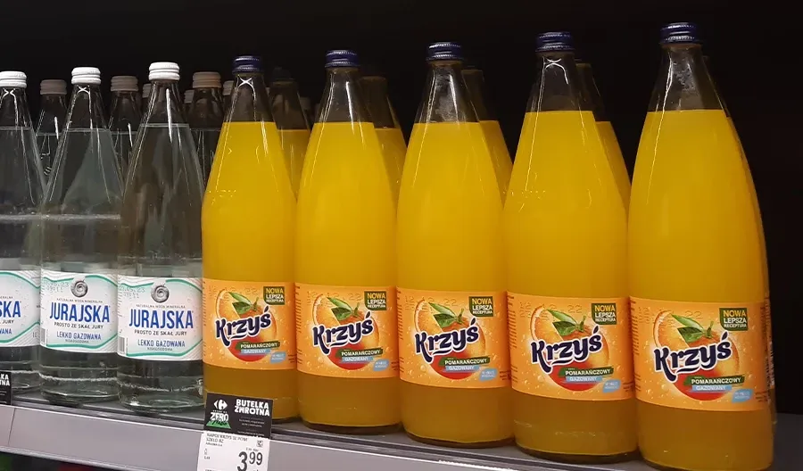 Szklana butelka napoju Krzyś pomarańczowy