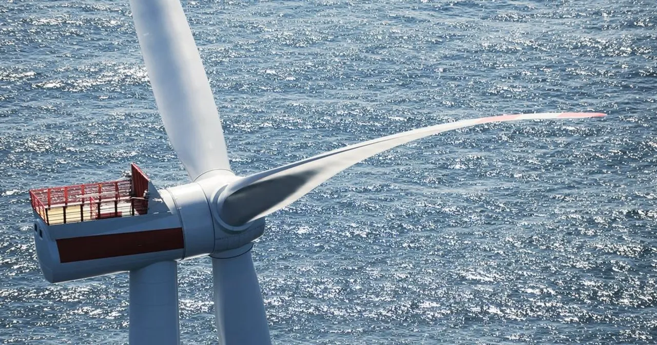 Turbina wiatrowa na morzu, element krajowego projektu energetycznego. Błękitna woda i białe łopaty tworzą obraz przyszłości.