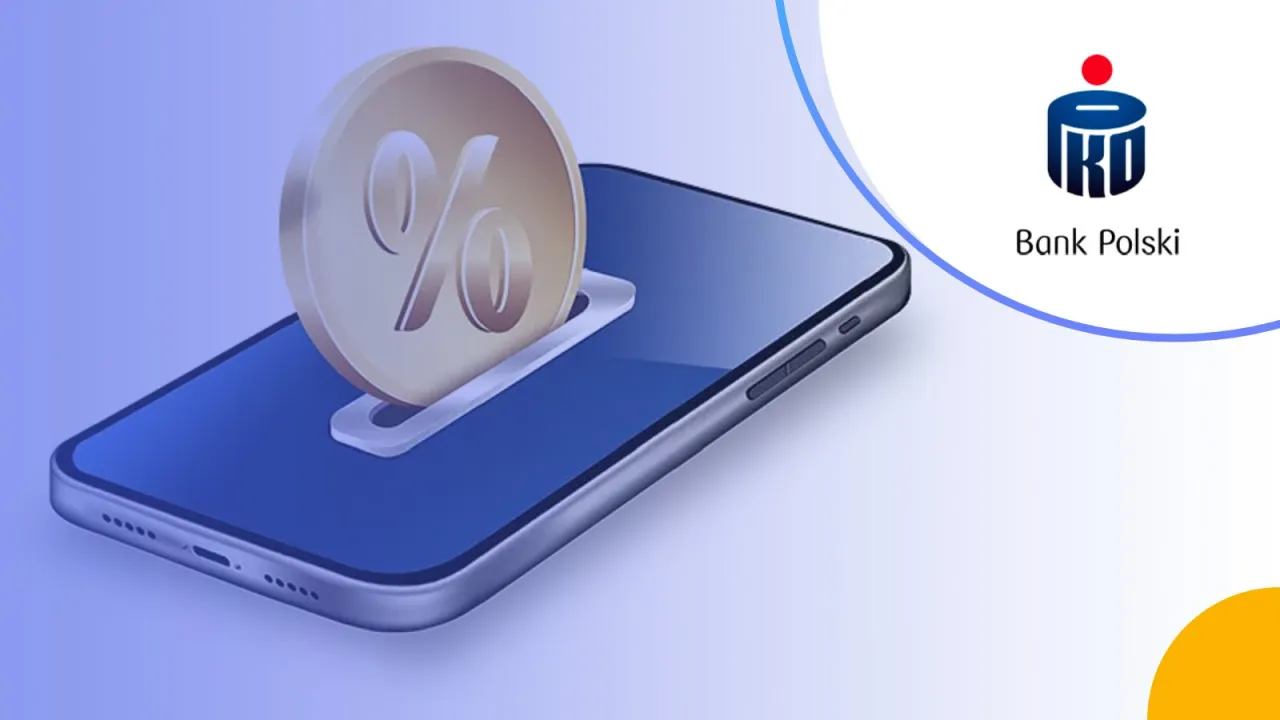 Moneta z symbolem procenta wsuwana do telefonu. To ilustracja tego, co to jest lokata mobilna w Banku Polskim.
