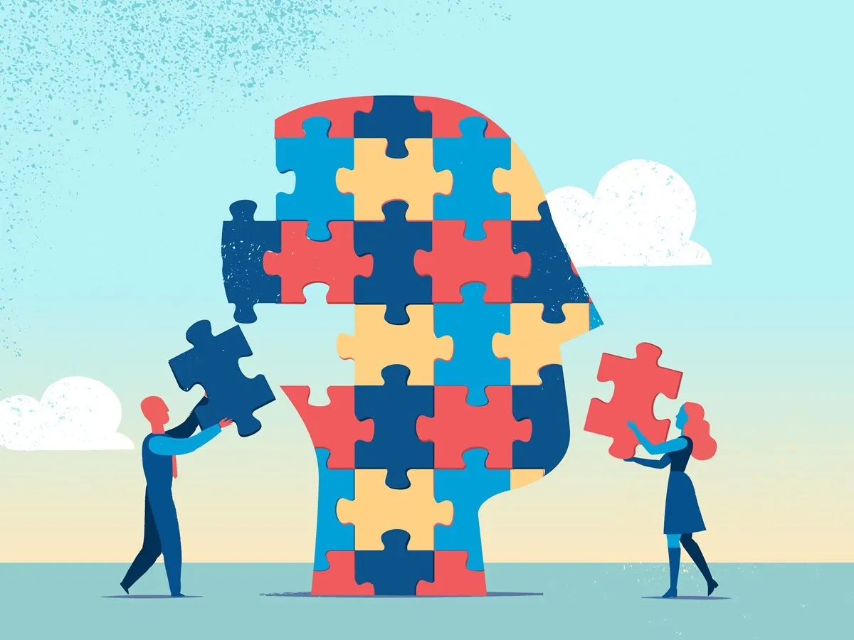 Ludzie składają głowę z puzzli, symbolizując zrozumienie najrzadszego typu osobowości.