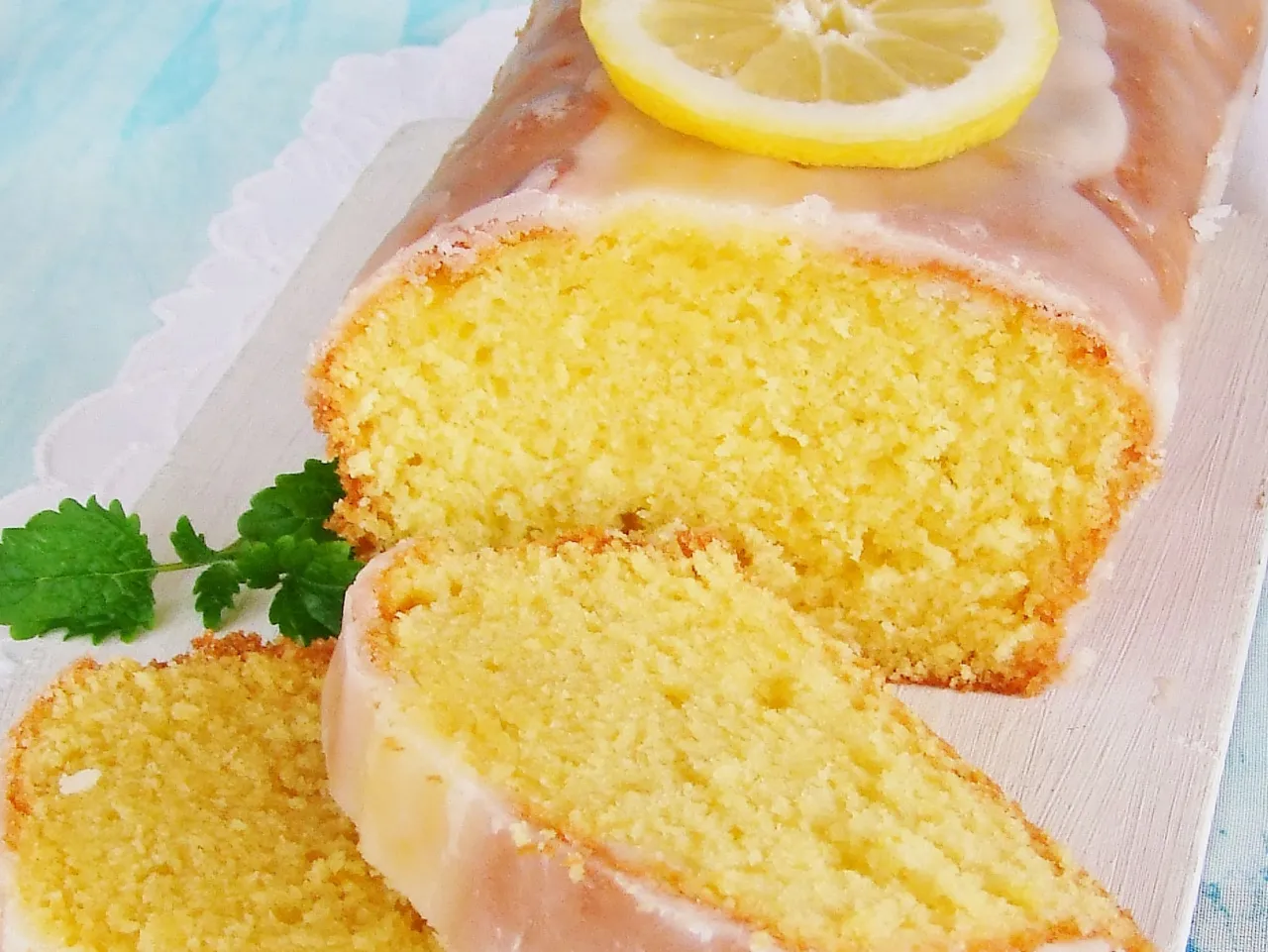 Puszyste ciasto mocno cytrynowe, polane lukrem i ozdobione plasterkiem cytryny. Idealne na letnie popołudnie.