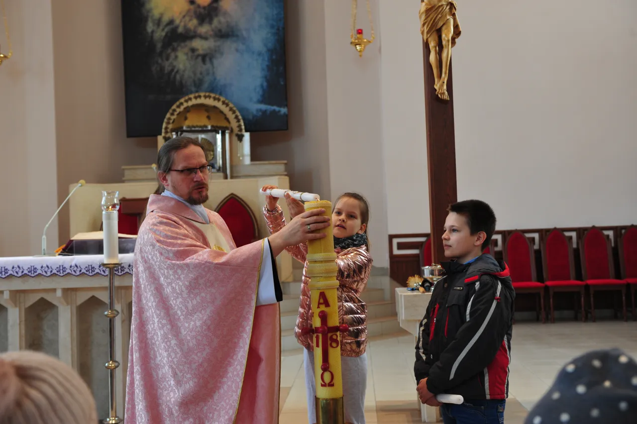 dzieci odnawiające przyrzeczenia chrzcielne w kościele