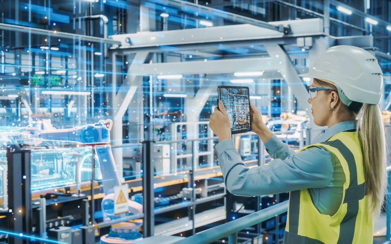 Inżynierka w fabryce przyszłości, gdzie jest wykorzystywana sztuczna inteligencja do sterowania robotami i optymalizacji proces&oacute;w.