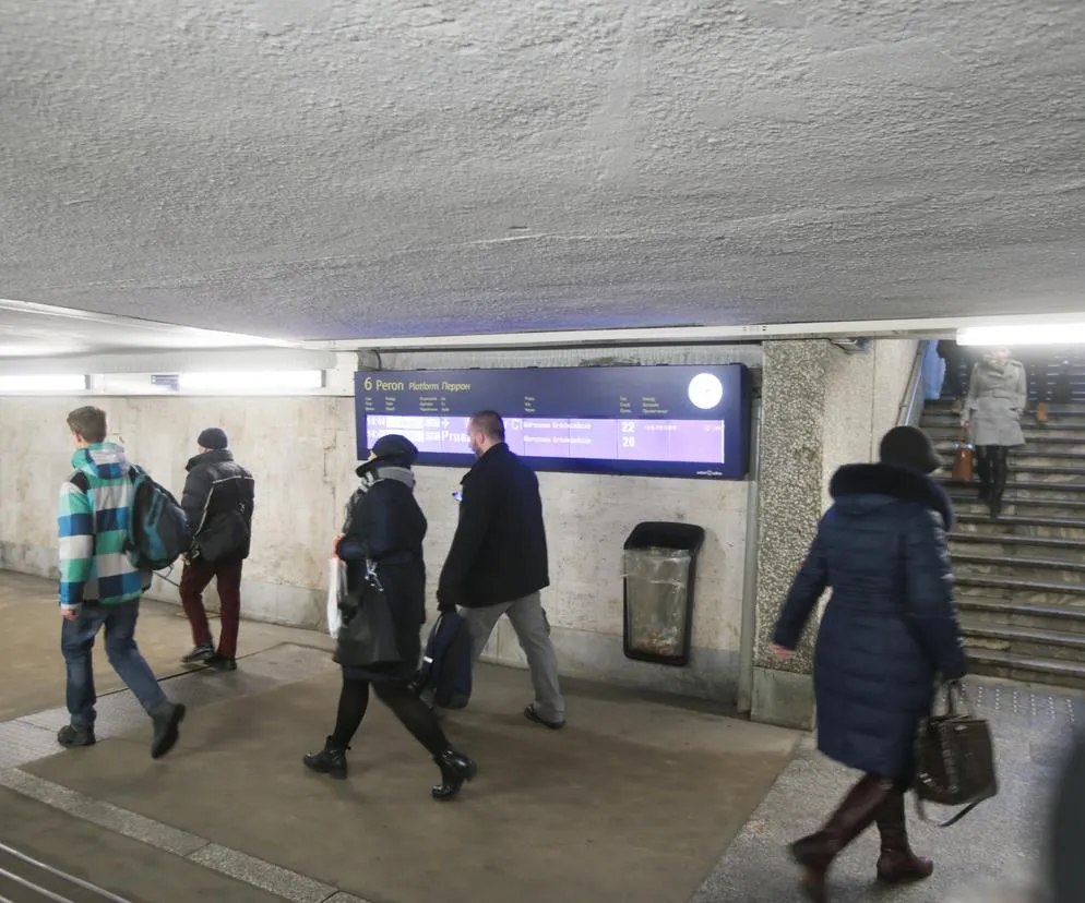 ludzie na dworcu kolejowym z biletami elektronicznymi i papierowymi