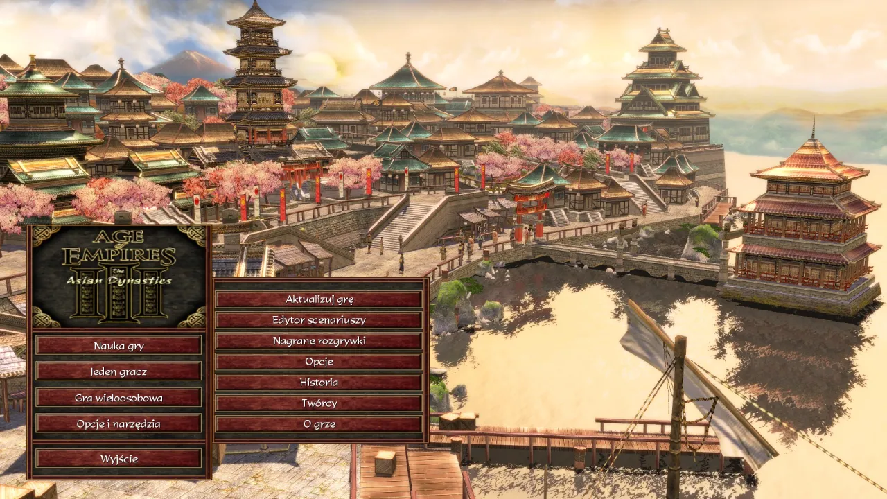 Menu gry Age of Empires III: The Asian Dynasties, z widokiem na azjatyckie miasto. W tle góra Fuji. Idealne do gry z age of empires 3 spolszczenie.