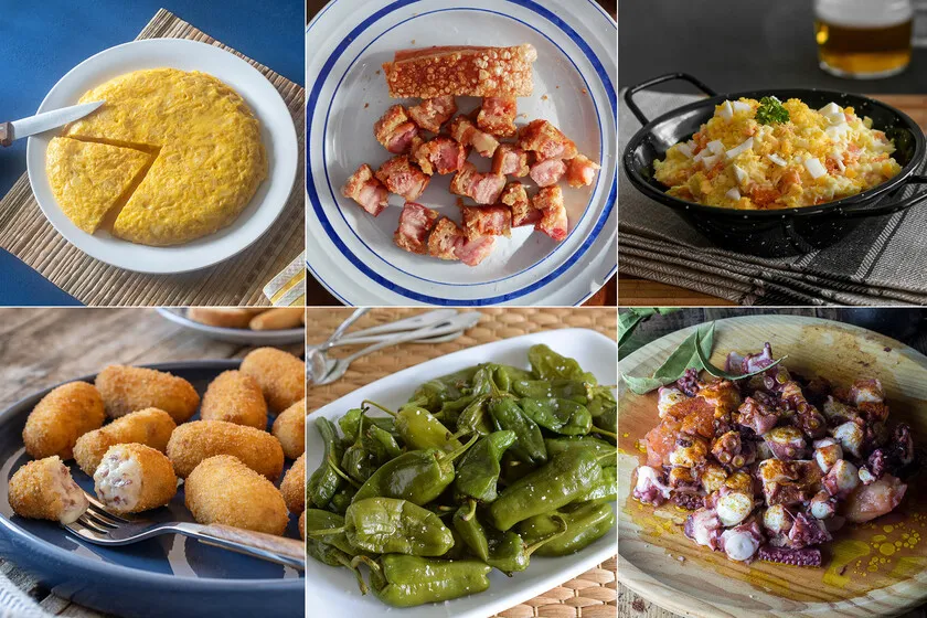diferentes tipos de tapas espa&ntilde;olas en una mesa: tortilla, gambas al ajillo, pintxos