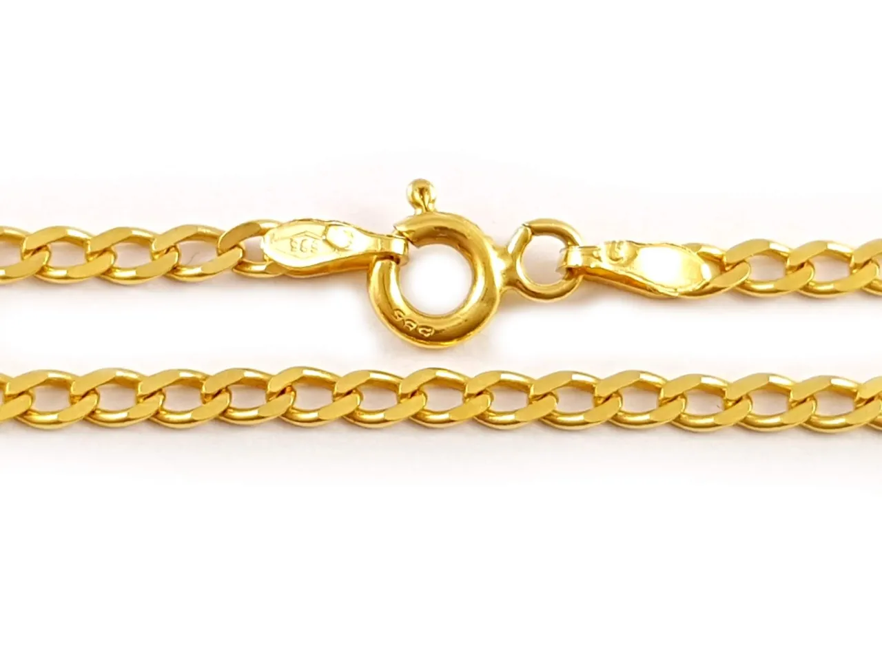 Złote sploty łańcuszk&oacute;w, zapięcie typu federing i karabińczyk. Delikatny blask złota.