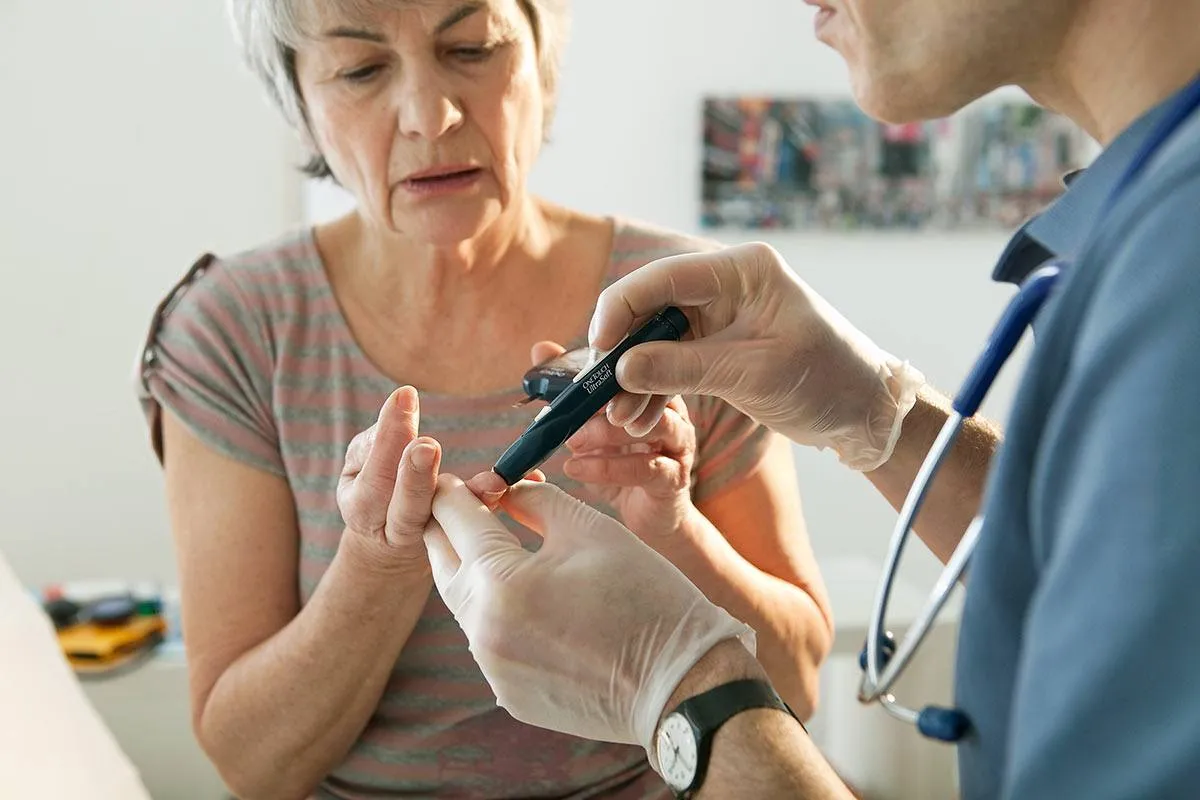 Lekarz bada poziom cukru we krwi pacjentki, co może być związane z doborem odpowiednich tabletek na cukrzycę na receptę.