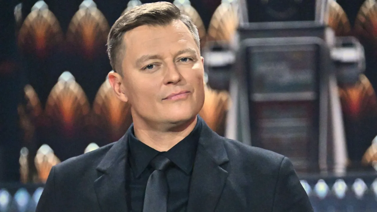 Rafał Brzozowski w czarnym garniturze, być może zastanawia się, dlaczego odszedł z Koła Fortuny.