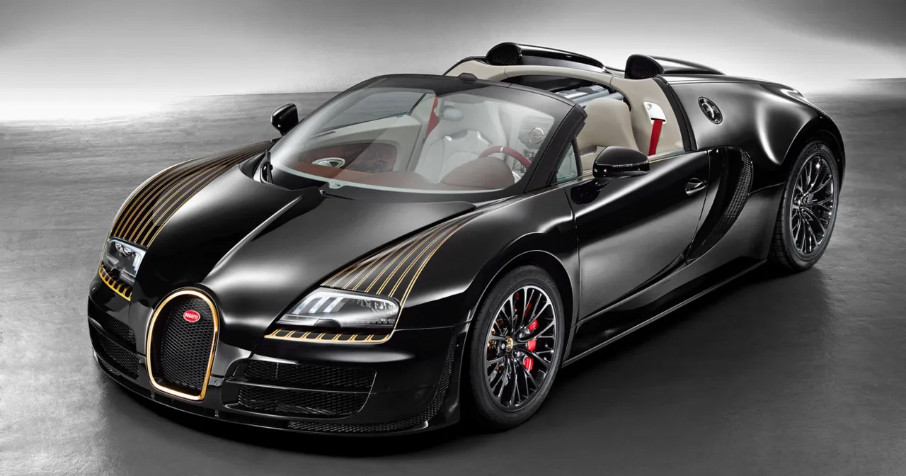 Czarny Bugatti Veyron z złotymi pasami na masce. Zastanawiasz się, ile kosztuje Bugatti Veyron? To marzenie wielu kierowc&oacute;w.