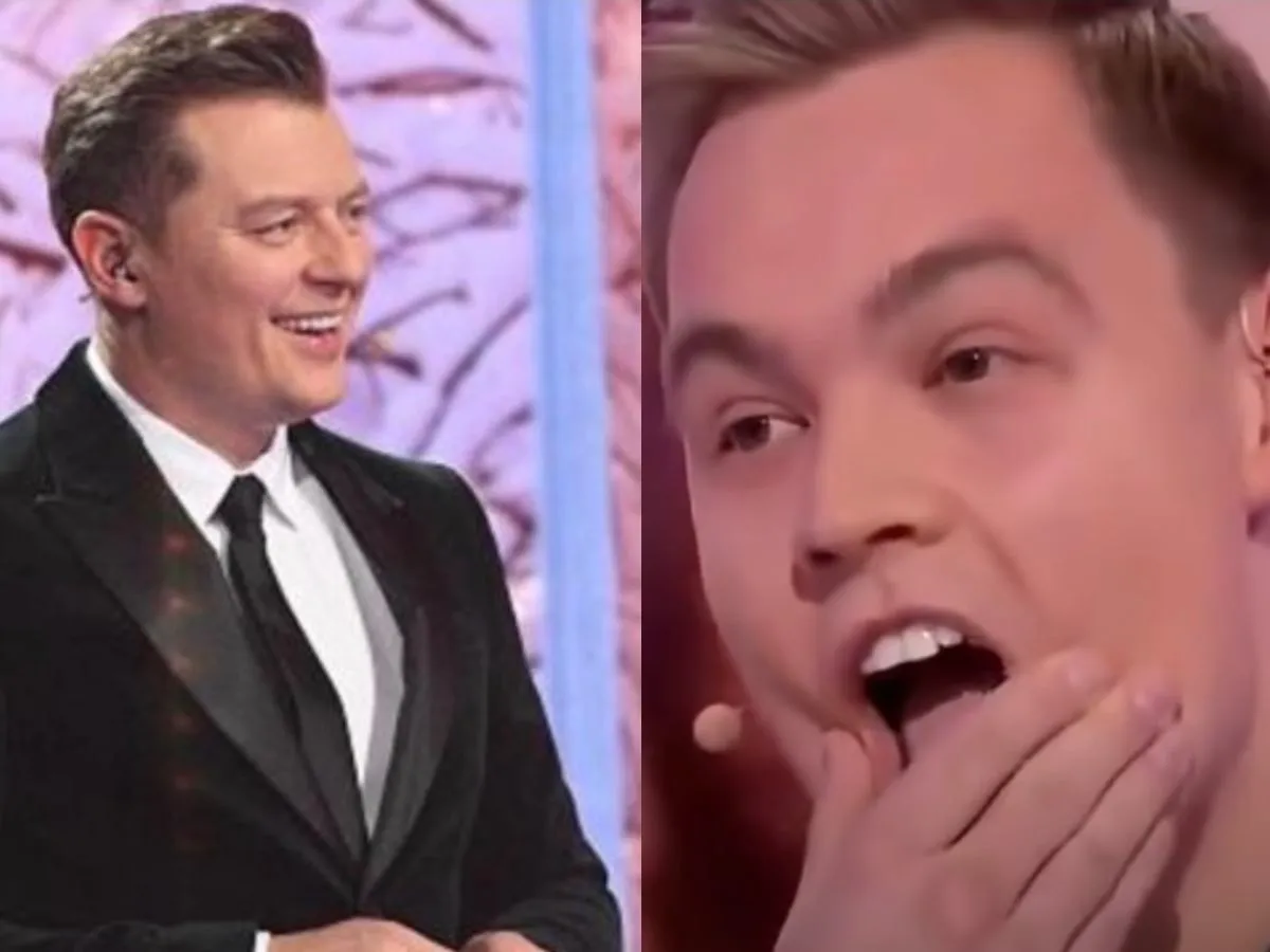 Krzysztof z Koła Fortuny w garniturze, uśmiechnięty i zaskoczony.