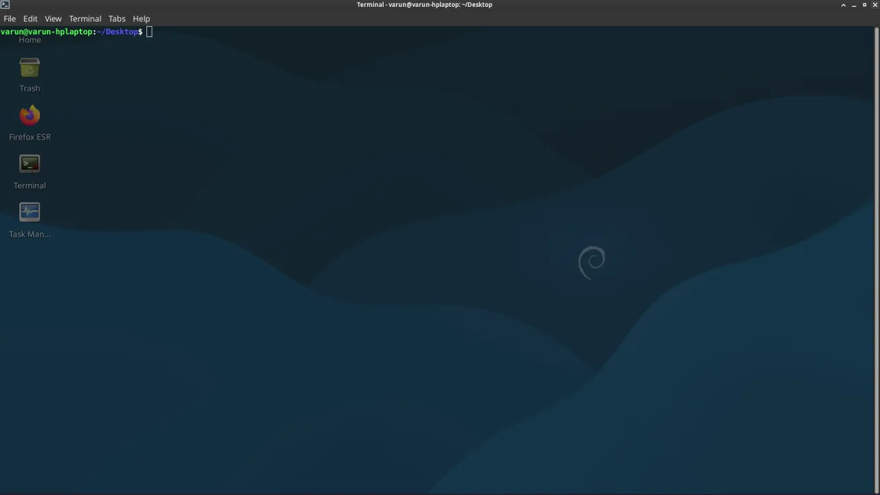Pulpit systemu Debian 10 z ikonami: Kosz, Firefox ESR, Terminal, Menedżer zadań.