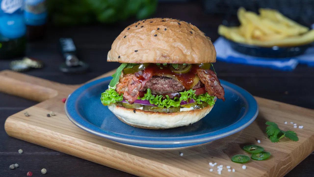 Pyszny burger z burgerowni, z bekonem i jalapeno. Zastanawiasz się, ile kcal ma taki burger?