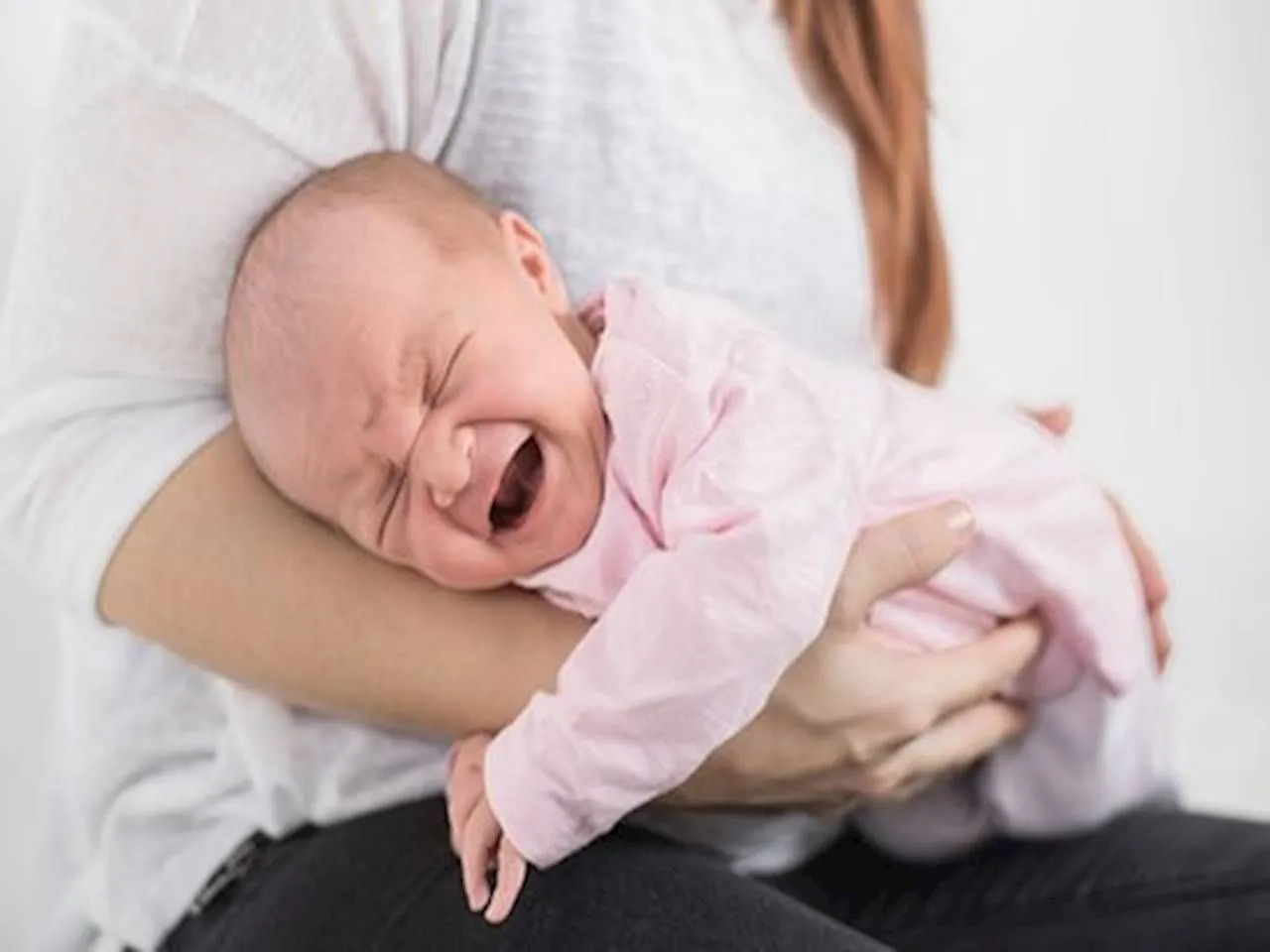 Płaczące niemowlę z bólem brzucha