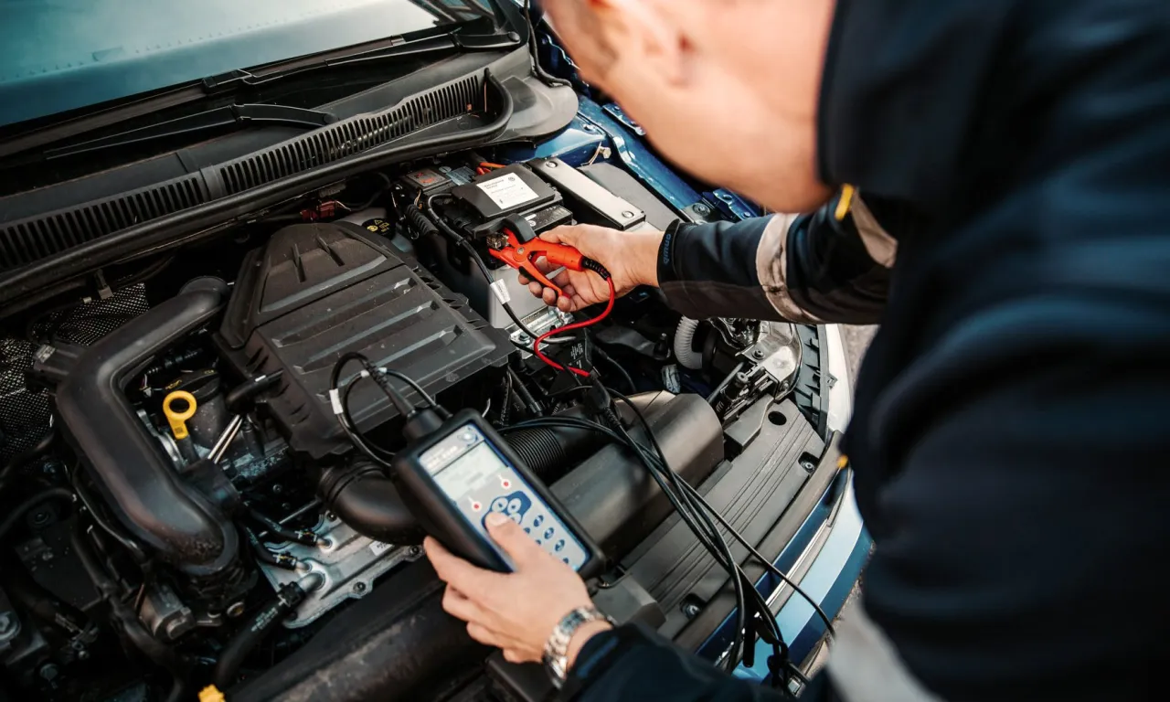 mechanik samochodowy rozmawiający z klientem, warsztat samochodowy z nowoczesnym sprzętem diagnostycznym