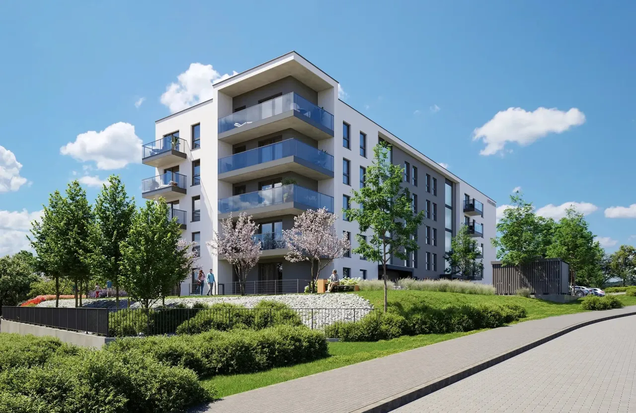 Nowoczesny blok mieszkalny w Gdańsku Chełmie z balkonami i zielonym otoczeniem.