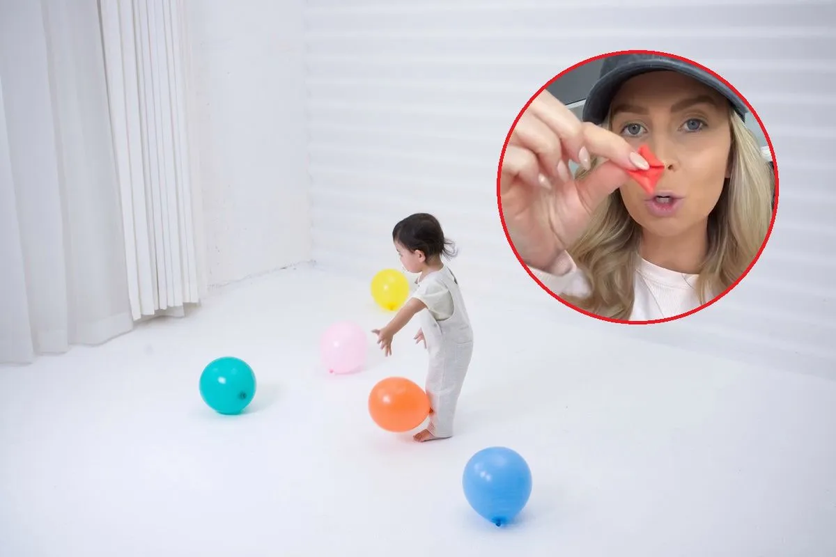 Dziecko przyciągające papierki balonem