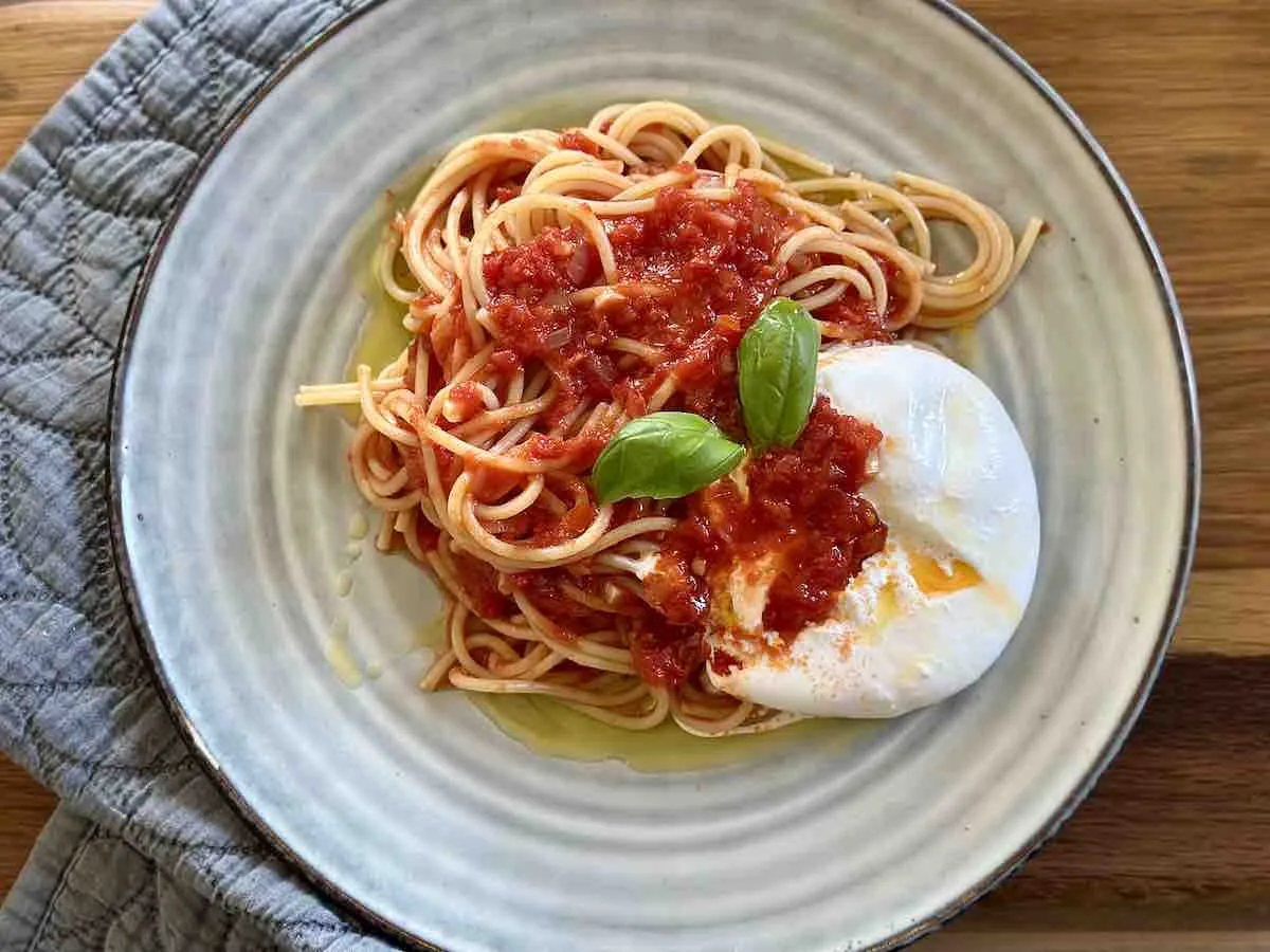 spaghetti z burratą na talerzu