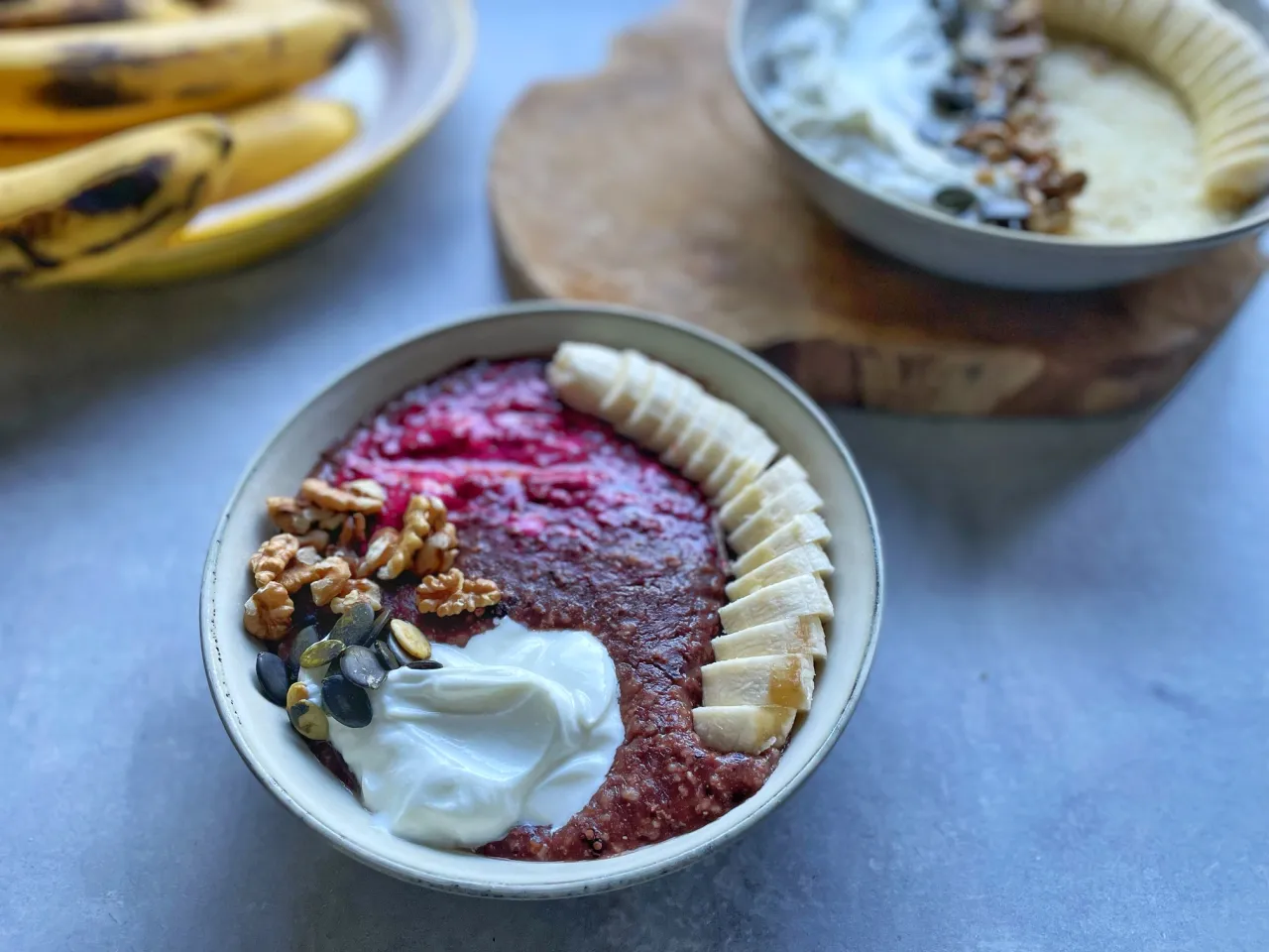 Pyszne śniadanie, idealne jako posiłek co jeść po treningu: owsianka z malinami, jogurtem, orzechami i bananem.