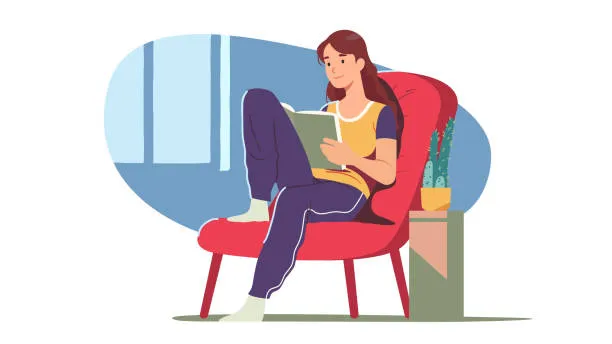 osoba relaksująca się z książką w domu