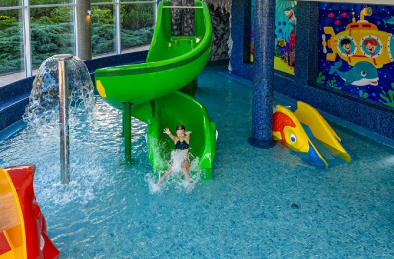 sala zabaw w hotelu z małym dzieckiem bawiącym się na zjeżdżalni