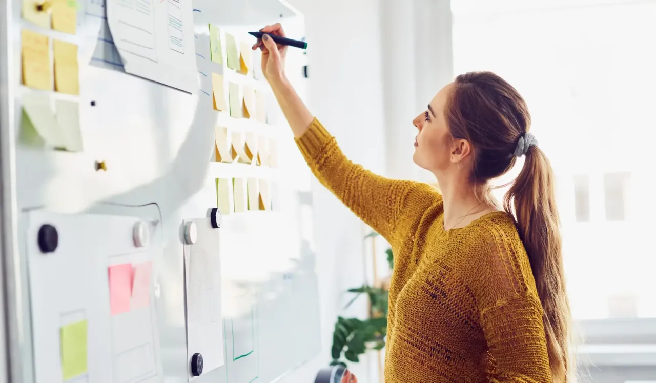 event manager planning conference on a large whiteboard