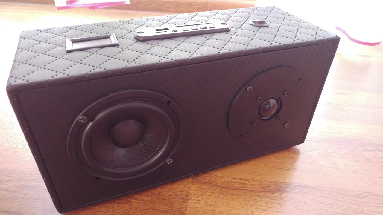 Domowy projekt: jak zrobić głośniki bluetooth. Czarny, pikowany głośnik z dwoma przetwornikami i panelem sterowania na górze.