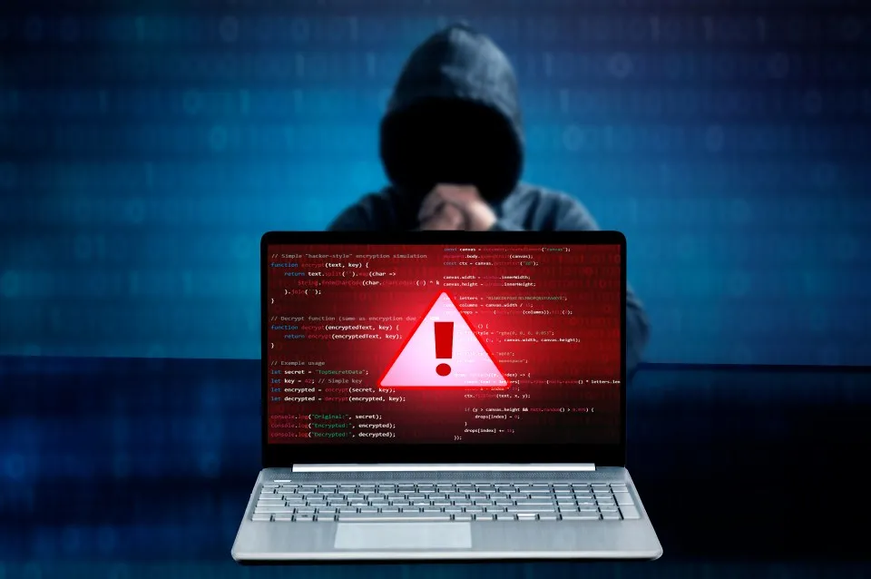 computer screen with spotify and a warning sign