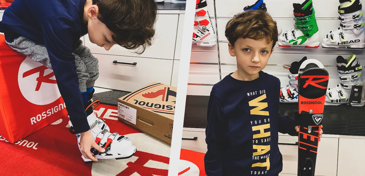 dziecko przymierza buty narciarskie w sklepie
