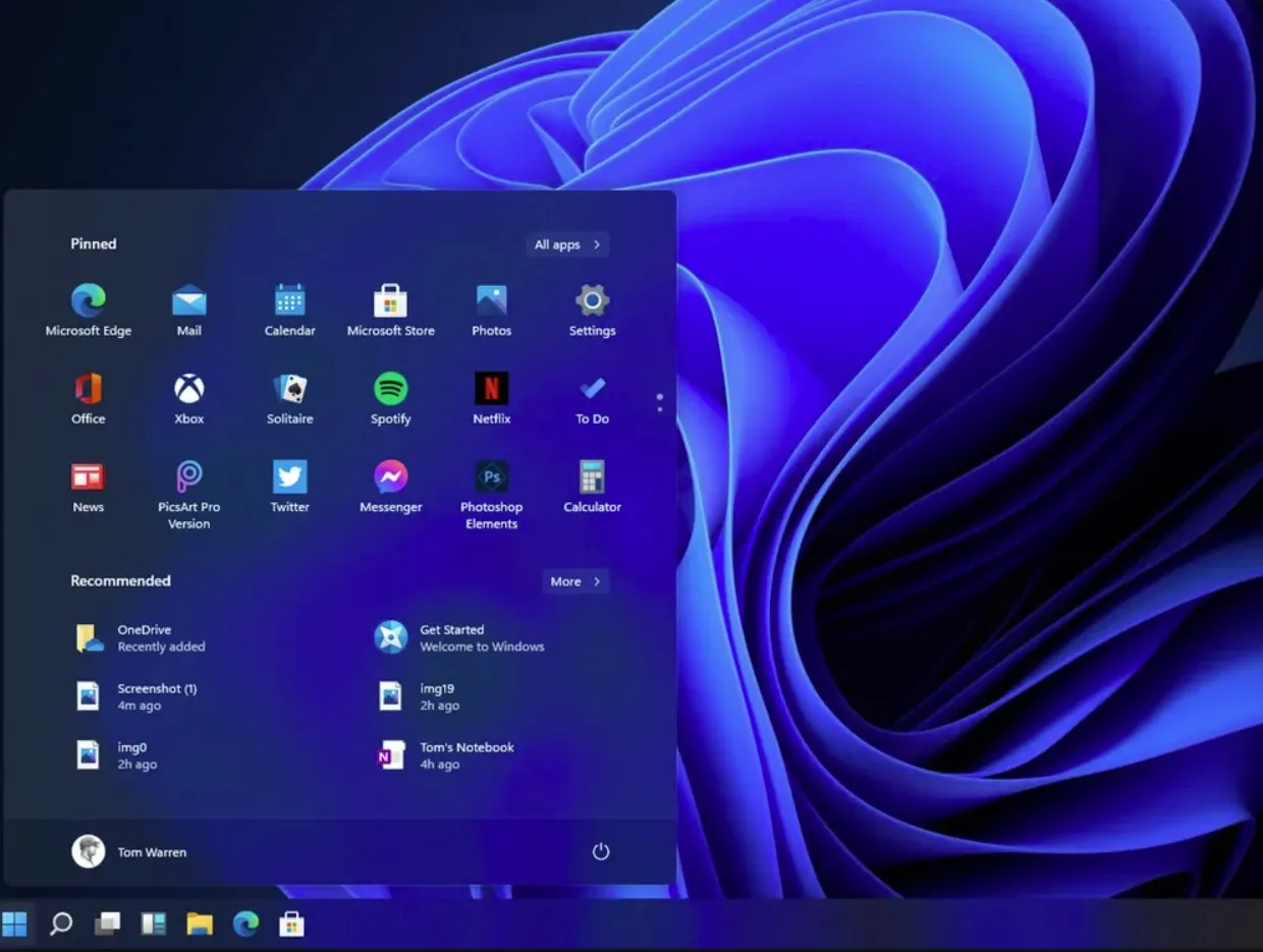 Menu Start w Windows 11 z przypiętymi aplikacjami i polecanymi plikami. Tło to charakterystyczna tapeta.