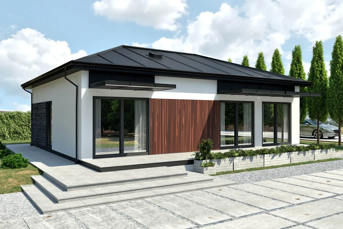Nowoczesny dom modułowy co to? Biały budynek z drewnianą elewacją, dużymi oknami i czarnym dachem.